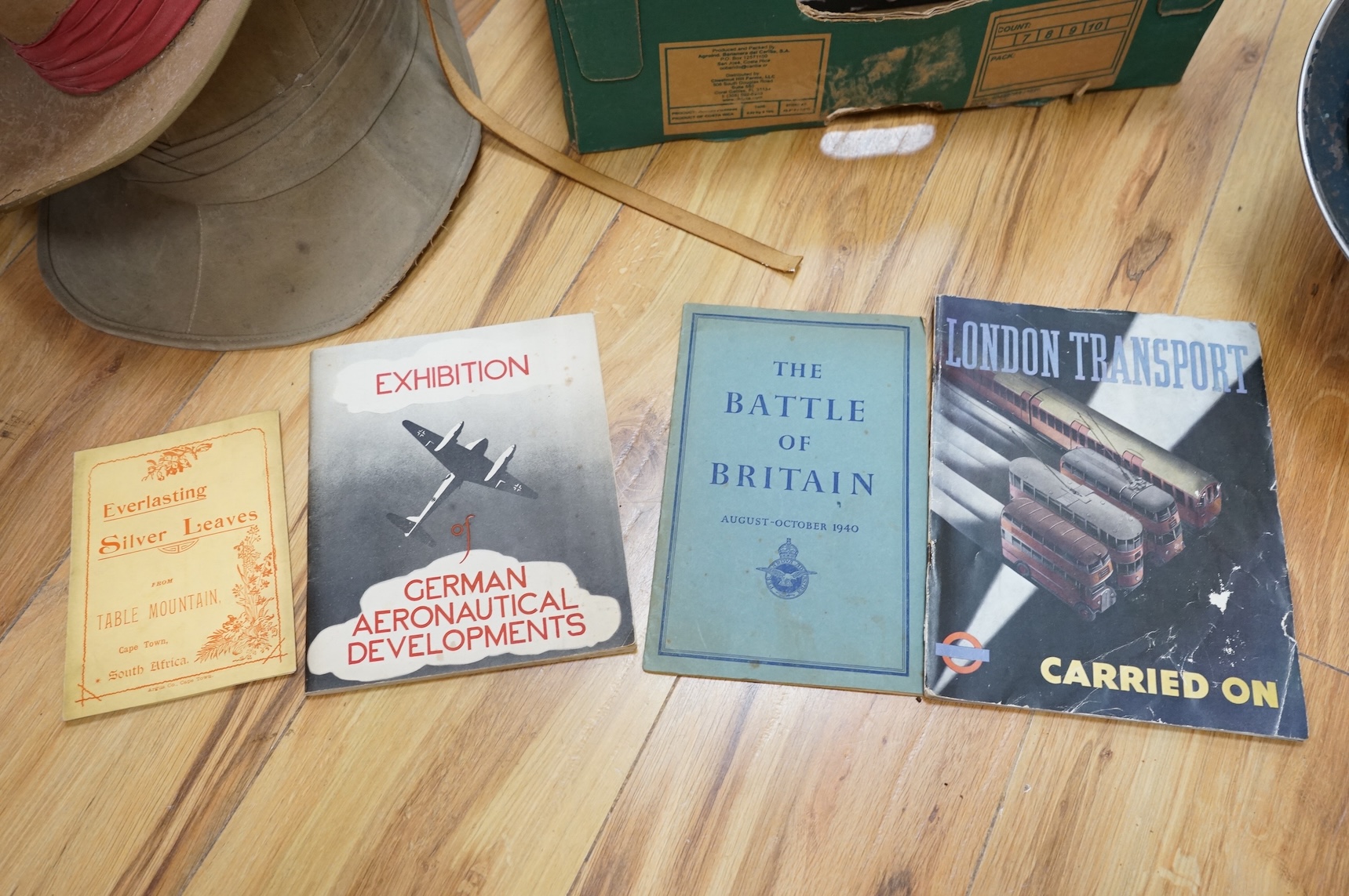 A collection of military related items, including an instrument panel from a WWII RAF Lancaster bomber aircraft, a Bosun’s whistle, a Heckler and Koch ‘bullet’ pen, a WWII tin hat (possibly police), a pith helmet, an Aus